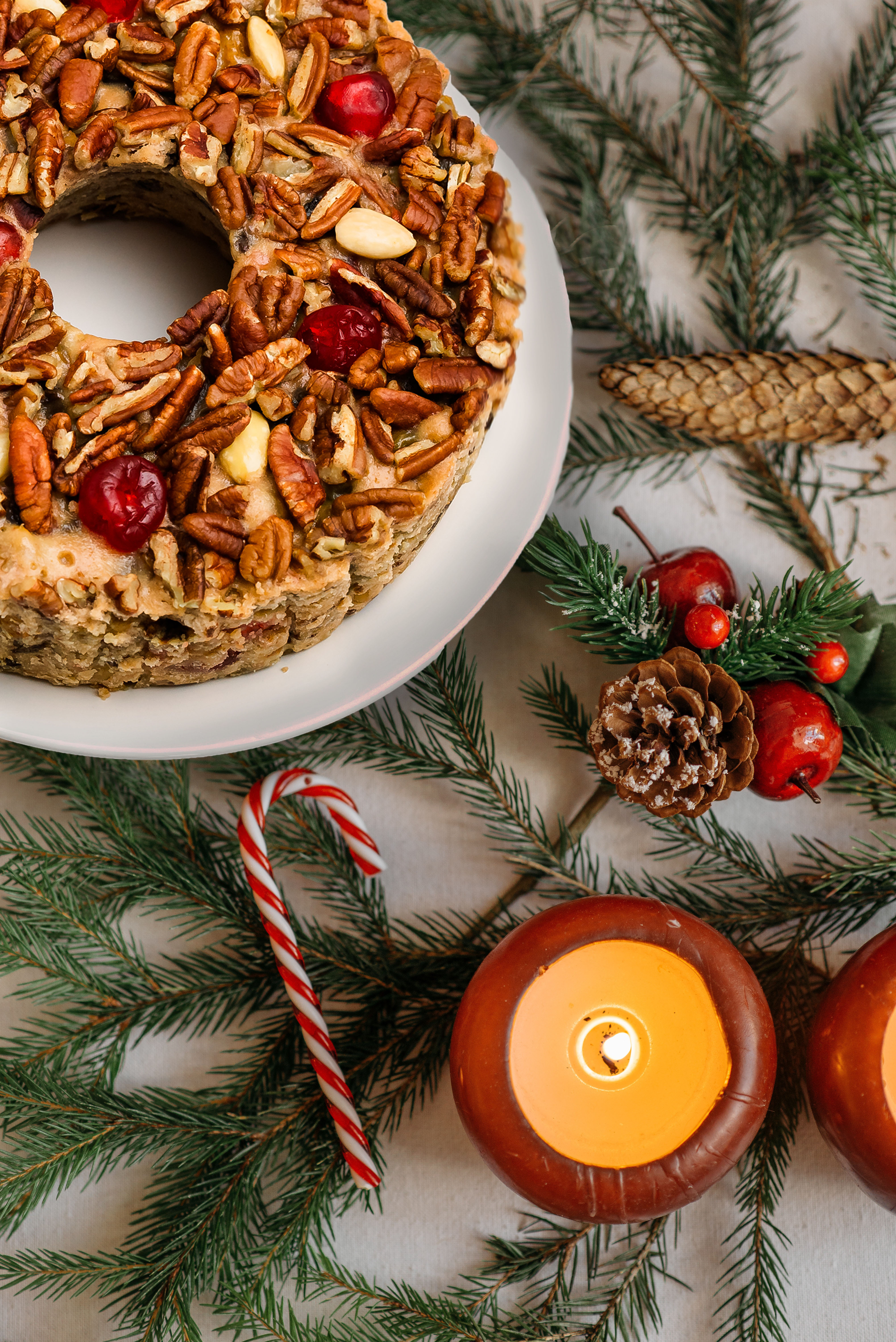 A coffee cake on display with holiday decorations in the background.