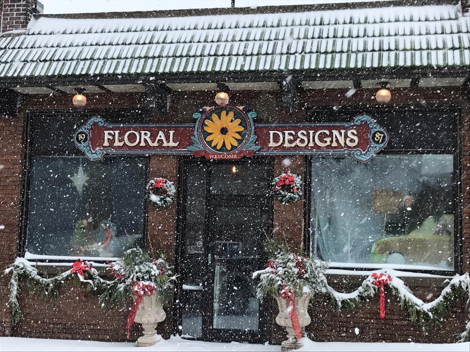 Store front of Floral Designs with a snow falling.