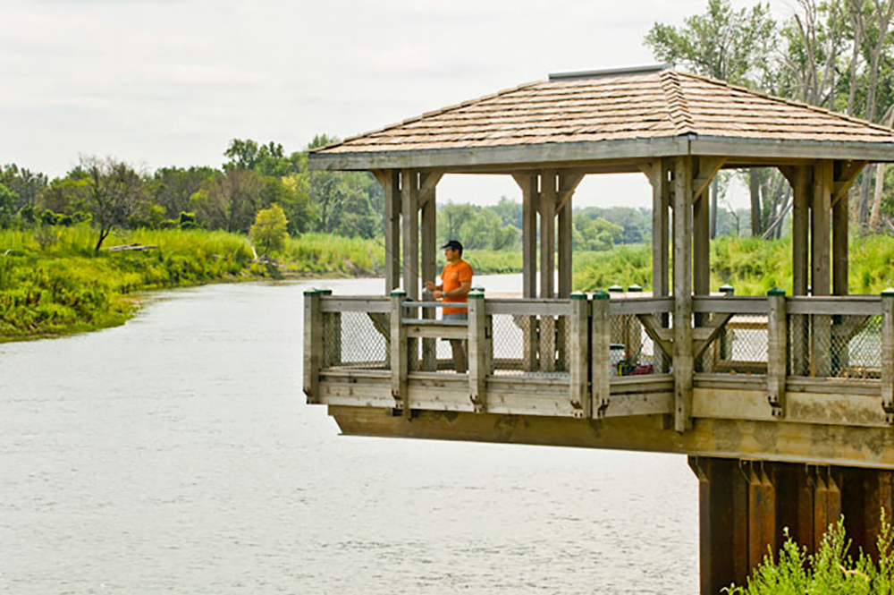 Man fishing from pier at Boyer Chute National Wildlife Refuge.