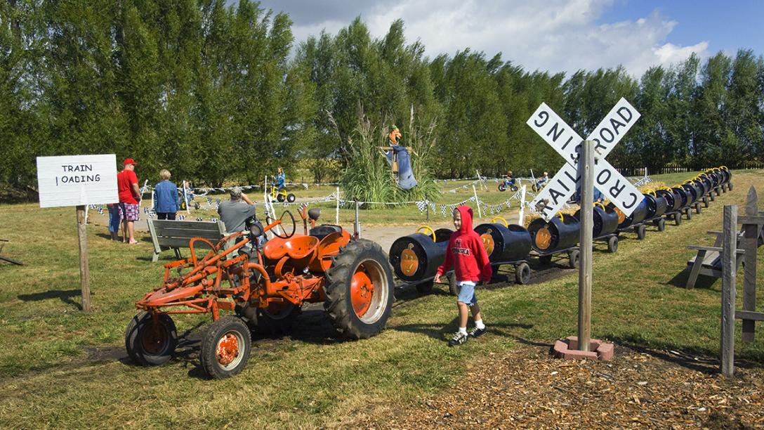 Kids playing on the tractor train and trikes at Helgoth's Pumpkin Patch.