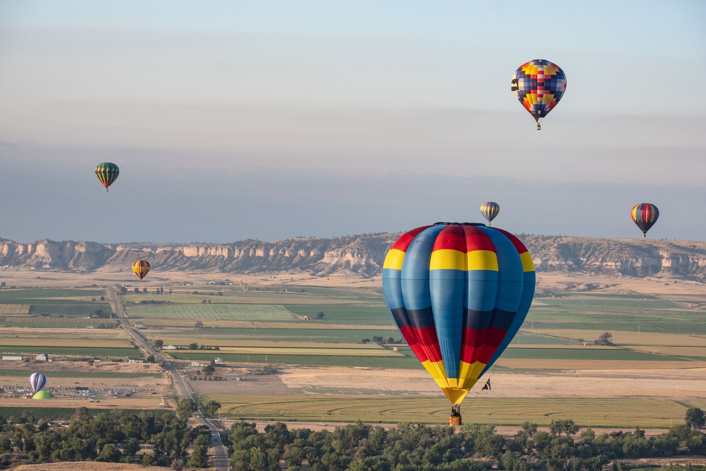 Hot air balloons flying over Scotts Bluff County at the Old West Balloon Fest