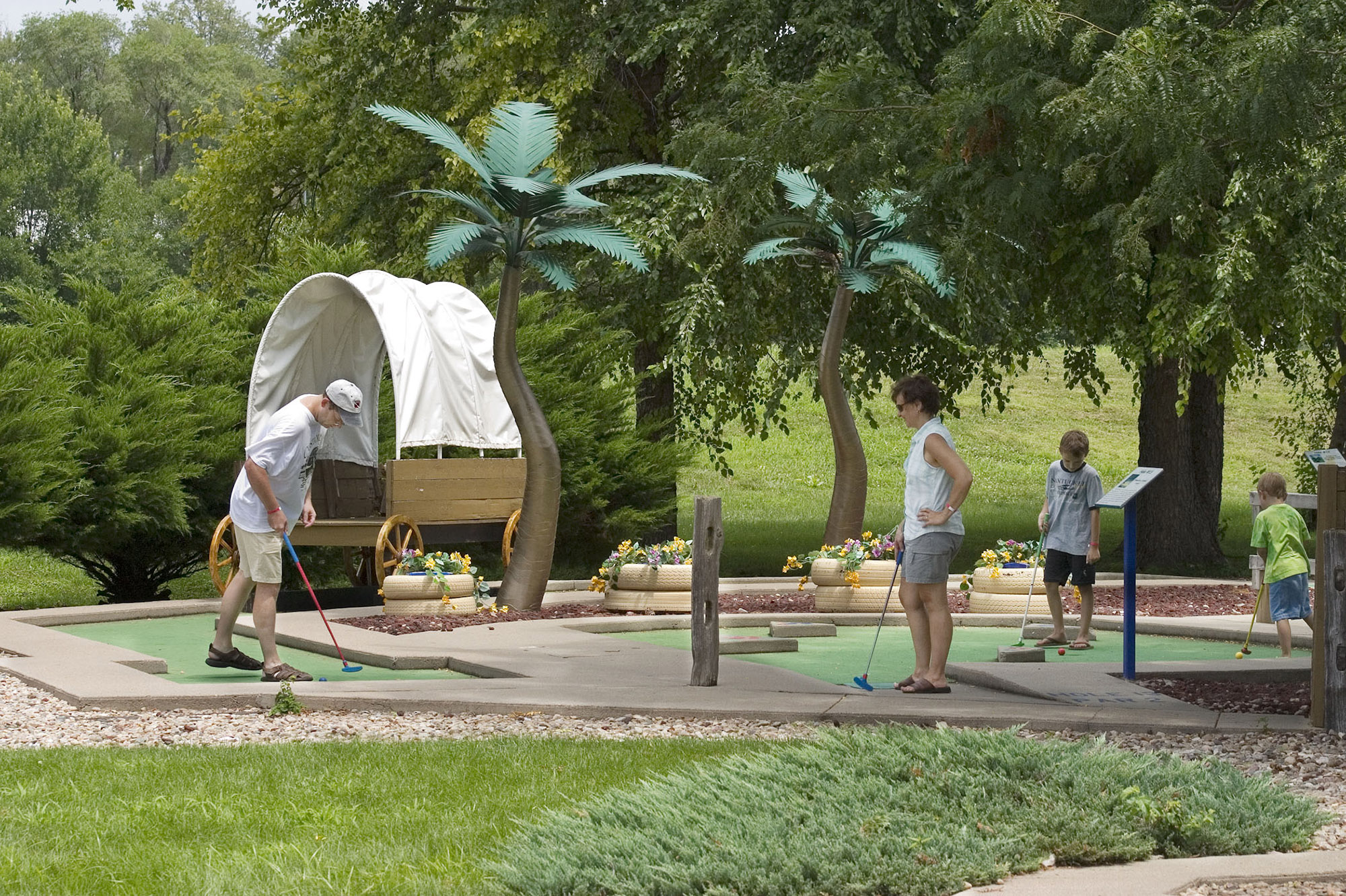 Family playing miniature golf at Papio Fun Park