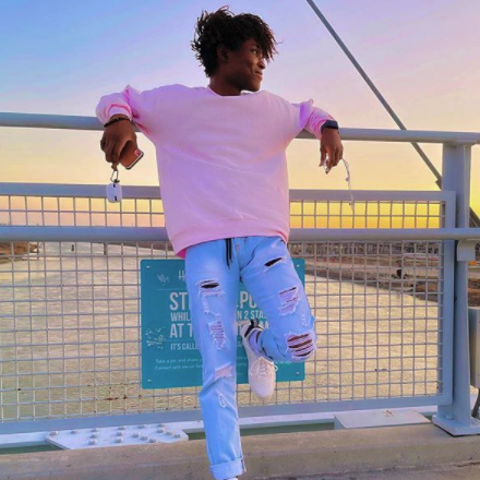 man on bridge at sunset