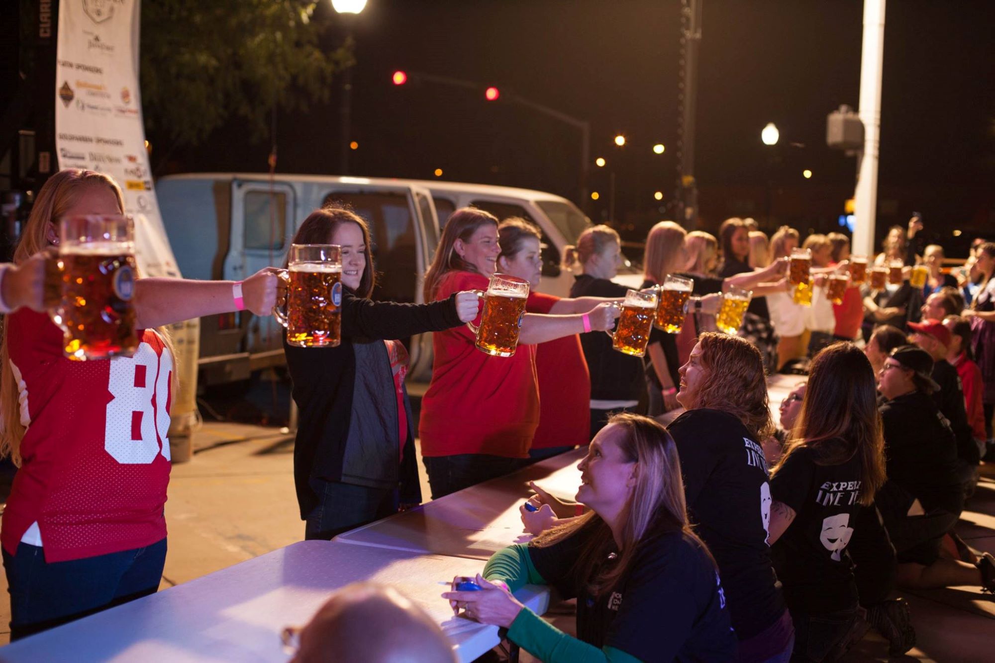 Groups holding beer steins at Norfolk Oktoberfest.