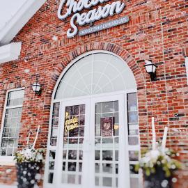 The outside of The Chocolate Season on a snowy afternoon.