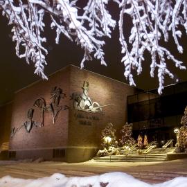 Outside of the Omaha Community Playhouse with holiday decorations on the trees.