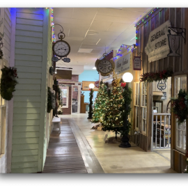 Store front of Plainsman Museum with holiday decorations.