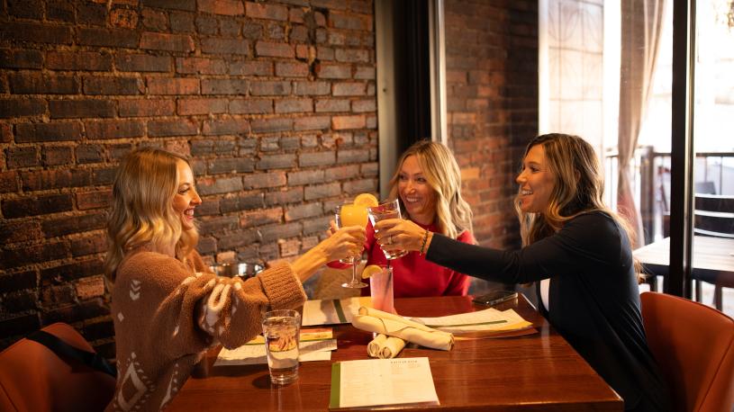 A group toasting a round of drinks at 411 Restaurant and Lounge in Norfolk.