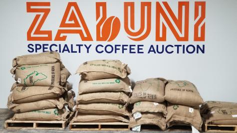 Zabuni Specialty Coffee log and bags of coffee beans.