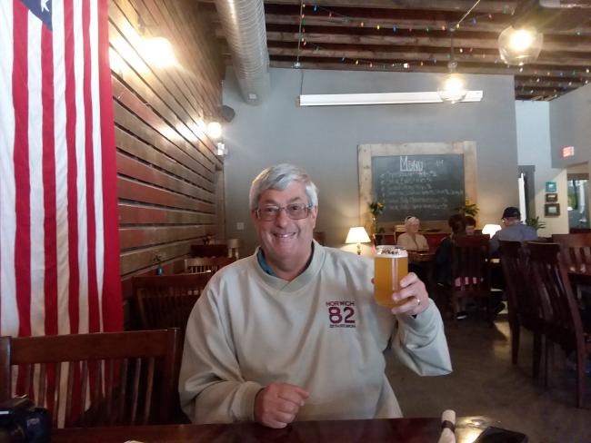 Man in Brewery holding Beer