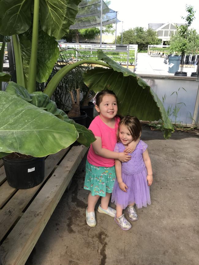 2 girls by plants